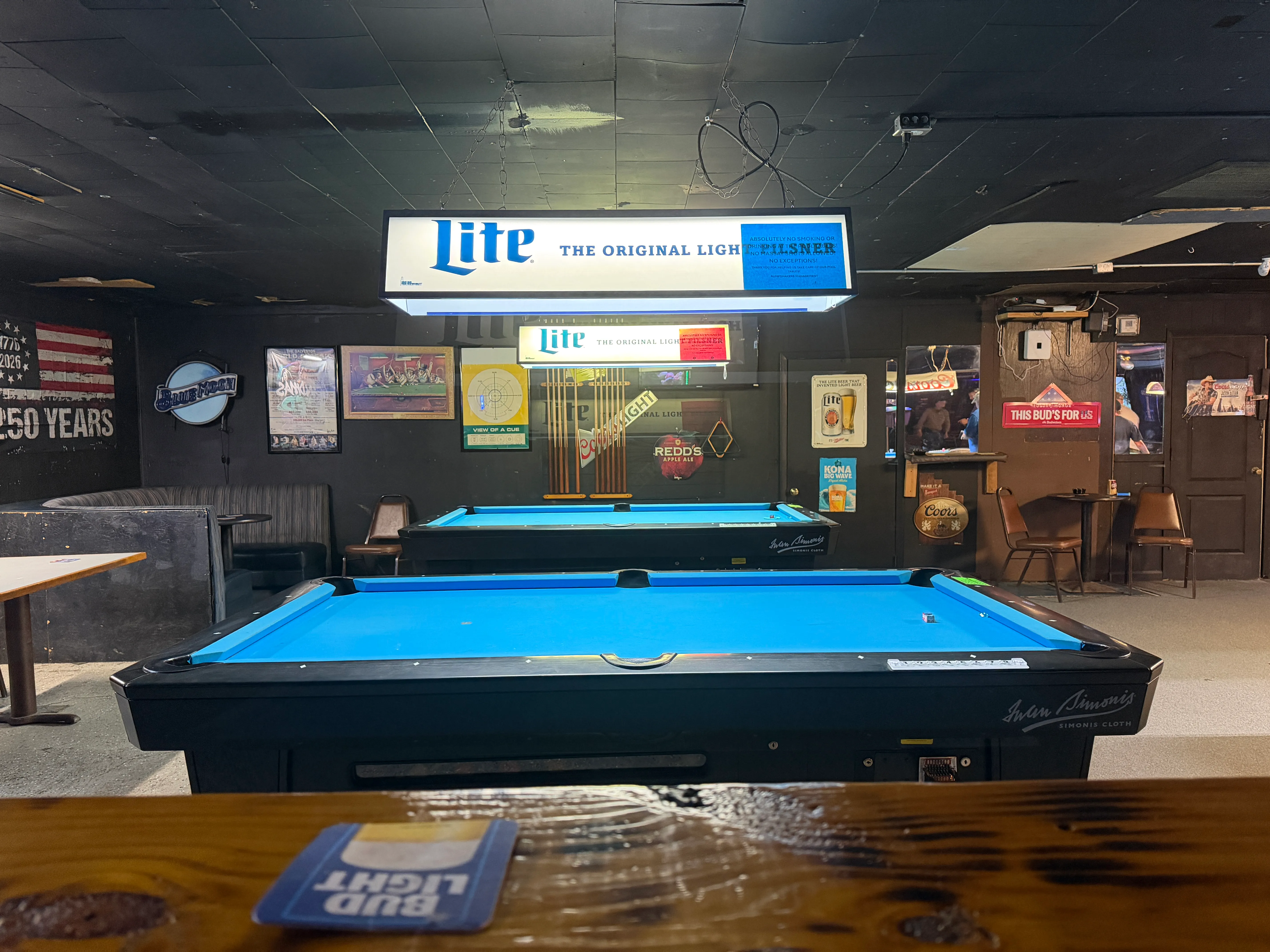 Blue-felt Diamond pool tables under table lamps